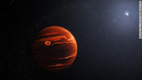 An illustration of exoplanet VHS 1256 b and its two stars.  