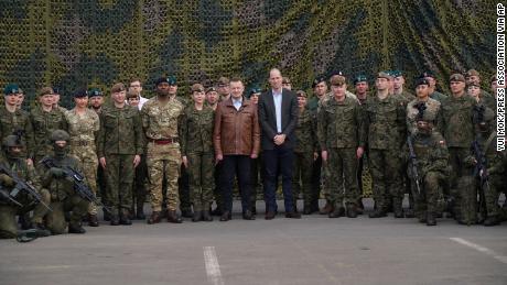 Prince William and Polish Deputy Prime Minister and Minister of Defence Mariusz Blaszczak (center left) pose for a group photo with British and Polish troops.