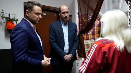 Prince William, center, and Mayor of Warsaw Rafal Trzaskowski, left, talk to an Ukrainian woman, who fled the war, during their visit to an accommodation centre in Warsaw, Poland on Wednesday evening.