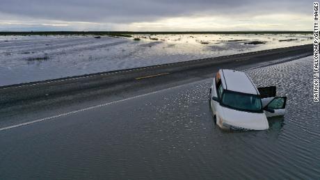 A vehicle submerges in flood waters in the Central Valley on March 22, 2023. 