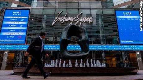 A pedestrian passes by the Hong Kong Stock Exchange electronic screen in Hong Kong on Monday, March 13, 2023. Asian shares mostly fell Monday, shaken by a Wall Street tumble that set off worries the biggest U.S. bank failure in nearly 15 years might have ripple effects around the world. (AP Photo/Louise Delmotte)
