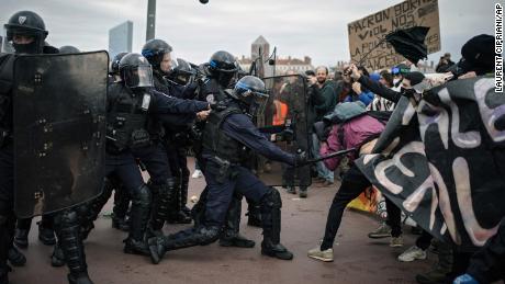 Protesters clash with police officers during a demonstration in Lyon, central France, Thursday, March 23, 2023. French unions are holding their first mass demonstrations Thursday since President Emmanuel Macron enflamed public anger by forcing a higher retirement age through parliament without a vote. (AP Photo/Laurent Cipriani)