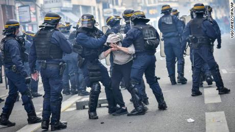 Anti-riot police arrest a man in Bordeaux during a demonstration on Thursday, a few days after the government pushed a pensions reform through French parliament without a vote. 