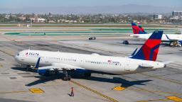 Penumpang Delta membuka pintu, menggunakan gelongsor pintu keluar kecemasan pada pesawat di lapangan terbang Los Angeles