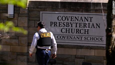 A police officer walks by an entrance to The Covenant School after a shooting on Monday.