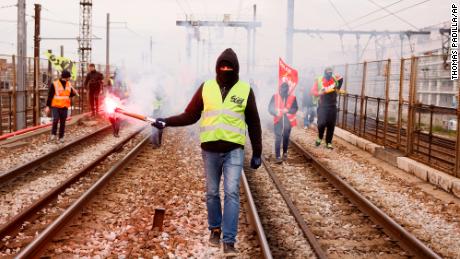 Railway workers demonstrate on the tracks at Gare de Lyon train station in Paris, France on Tuesday, as a fresh round of demonstrations is planned against proposed pension reforms.