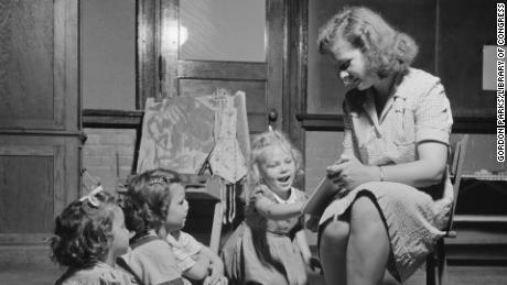 In this September 1942 photo, a child care worker reads a story at a child care center in New Britain, Connecticut. 