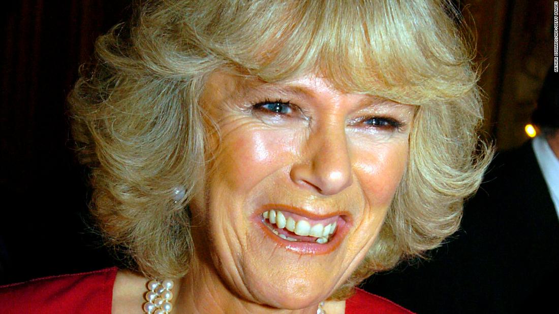 Camilla shows off her engagement ring as she and Prince Charles arrive for a party at Windsor Castle in February 2005.
