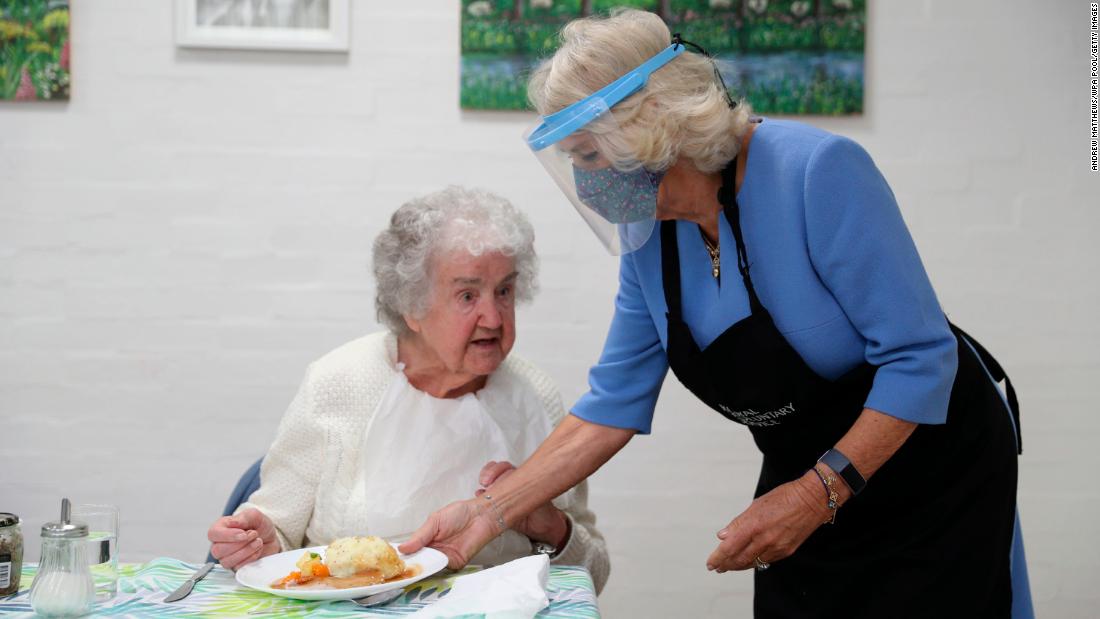 Camilla serves lunch at the Royal Voluntary Service Club in Rickmansworth, England, in October 2020. She was wearing a face shield because of the Covid-19 pandemic.