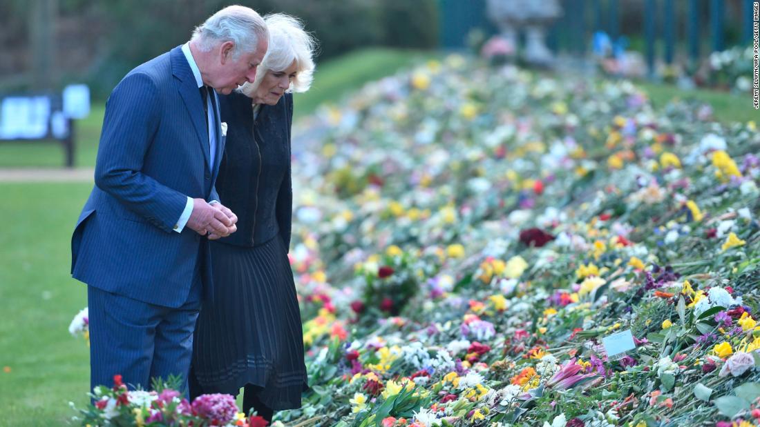 Charles and Camilla view flowers and messages left outside Buckingham Palace after the death of Charles&#39; father, Prince Philip, in April 2021.