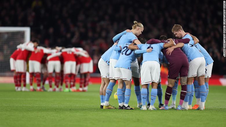  Arsenal and Manchester City teams huddle before the Premier League match between Arsenal FC and Manchester City at Emirates Stadium on February 15, 2023 in London, England.