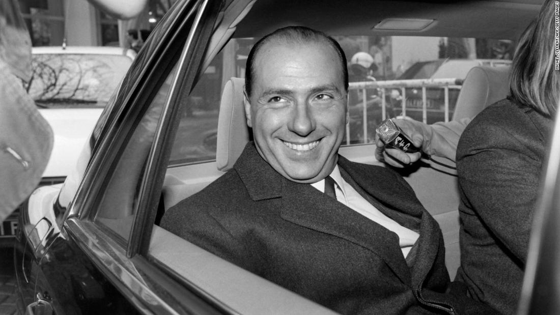 Berlusconi leaves a 1985 news conference in Paris.
