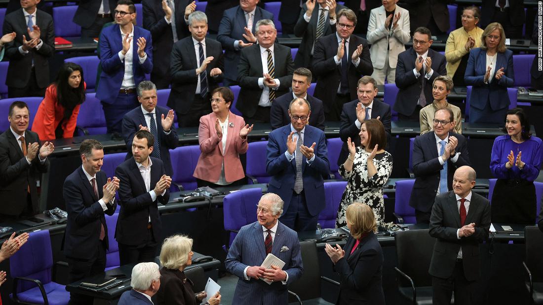 The King, front center, receives applause after delivering a speech at the Bundestag, Germany&#39;s parliament, on Thursday. He said he was proud to be in Berlin to &quot;renew the special bond of friendship between our two countries,&quot; and he said the friendship between the two nations &quot;meant so much to my beloved mother,&quot; who spoke often of her visits to the country.