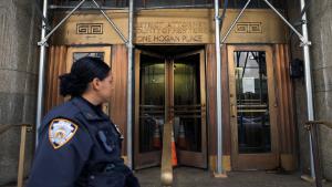 A New York City Police Department (NYPD) officer walks by the office of Manhattan District Attorney Alvin Bragg as he continues his investigation into former U.S. President Donald Trump, in Manhattan, New York City, U.S., March 18, 2023. REUTERS/Andrew Kelly