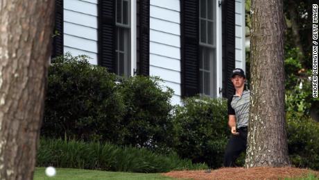 McIlroy watches his shot after his initial drive from the 10th tee put him close to Augusta&#39;s cabins.