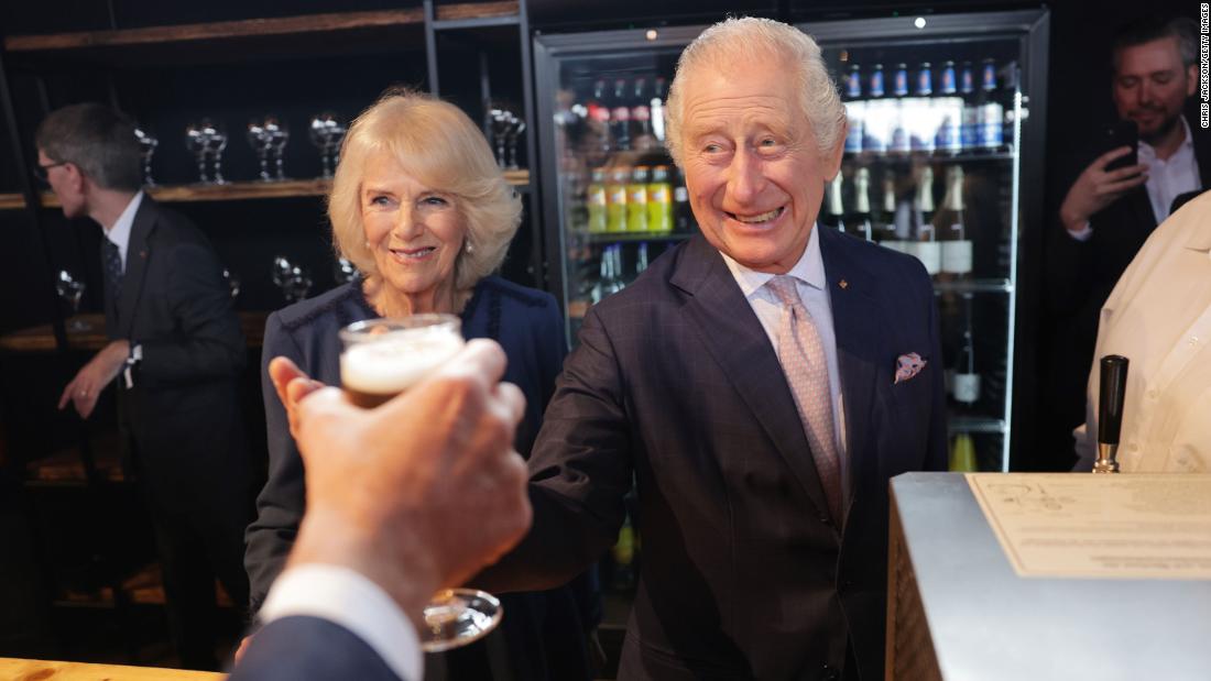 The King and Queen Consort make a toast at their final reception in Hamburg.