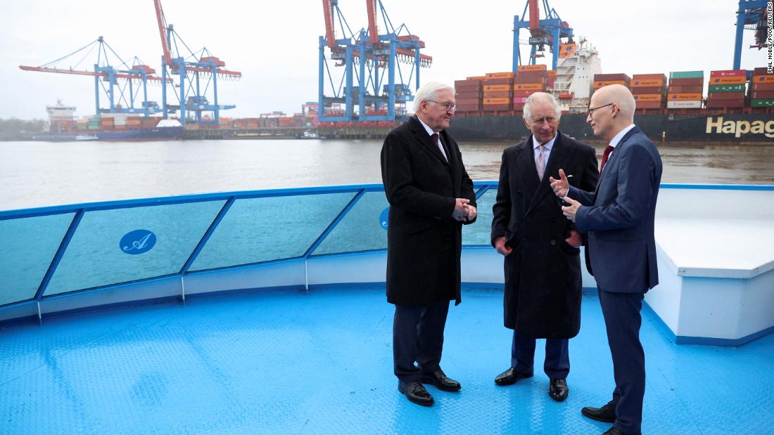 German President Frank-Walter Steinmeier, left, and the King speak with Hamburg Mayor Peter Tschentscher as they tour Hamburg&#39;s harbor on Friday.