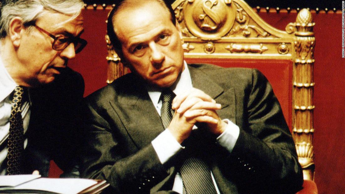 Berlusconi chats with lawmaker Cesare Previti at the Italian Senate during a vote of confidence for Berlusconi&#39;s government in May 1994.