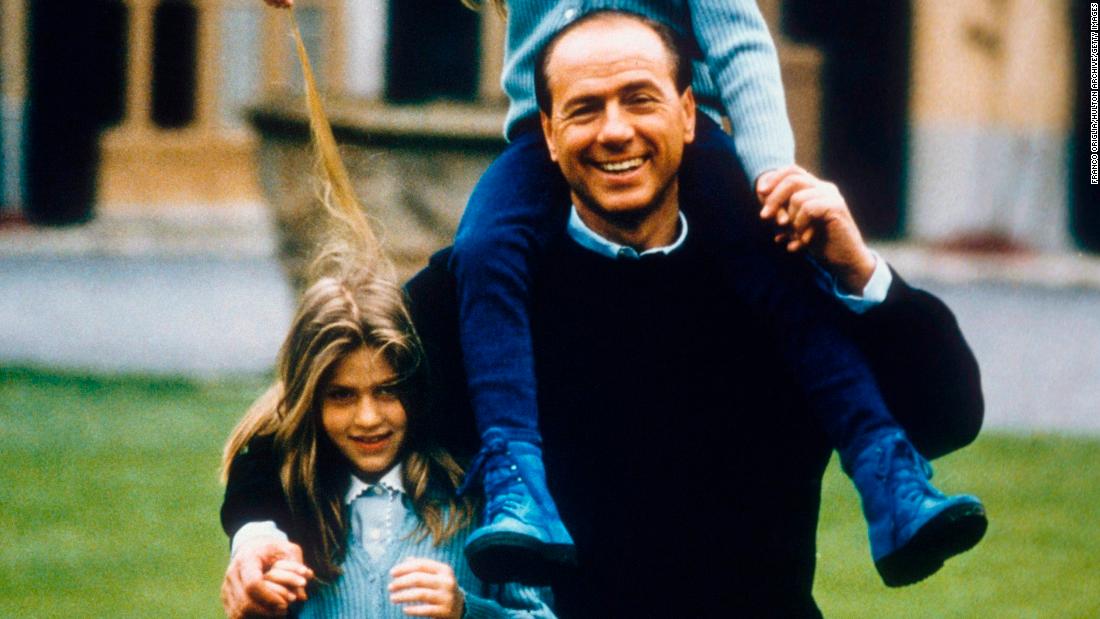 Berlusconi plays with daughters Barbara, left, and Eleonora in Milan.