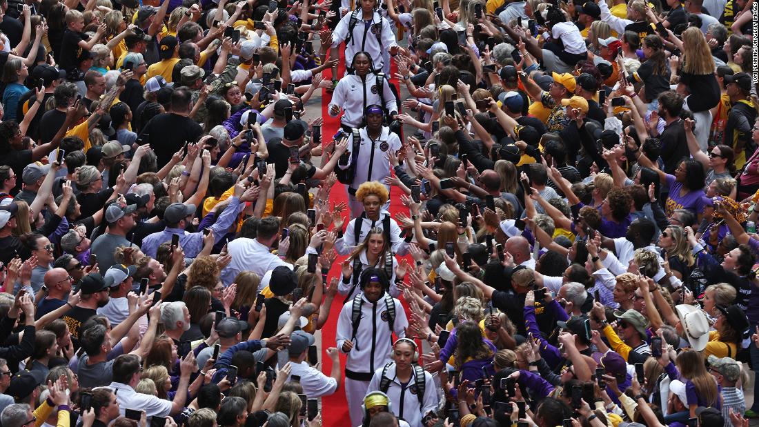 LSU players high-five fans on their way to the game.