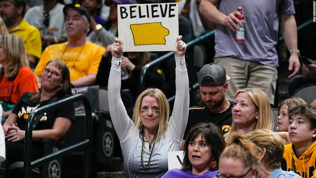 An Iowa fan holds a &quot;believe&quot; sign during the second half.