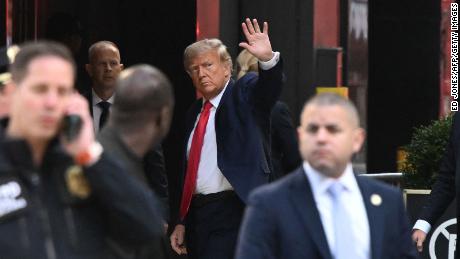 Former US President Donald Trump waves as he arrives at Trump Tower in New York on April 3, 2023. - Trump arrived on April 3, 2023 in New York where he will surrender to unprecedented criminal charges, taking America into uncharted and potentially volatile territory as he seeks to regain the presidency. The 76-year-old Republican, the first US president ever to be criminally indicted, will be formally charged Tuesday over hush money paid to a porn star during the 2016 election campaign. (Photo by Ed JONES / AFP) (Photo by ED JONES/AFP via Getty Images)