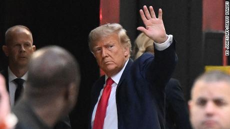 Former US President Donald Trump waves as he arrives at Trump Tower in New York on April 3, 2023. - Trump arrived on April 3, 2023 in New York where he will surrender to unprecedented criminal charges, taking America into uncharted and potentially volatile territory as he seeks to regain the presidency. The 76-year-old Republican, the first US president ever to be criminally indicted, will be formally charged Tuesday over hush money paid to a porn star during the 2016 election campaign. (Photo by Ed JONES / AFP) (Photo by ED JONES/AFP via Getty Images)