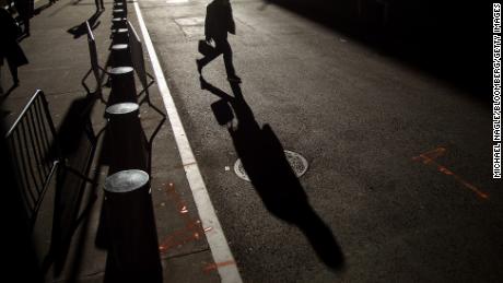 Pedestrians walk along Wall Street near the New York Stock Exchange (NYSE) in New York, US, on Wednesday, Nov. 9, 2022. 