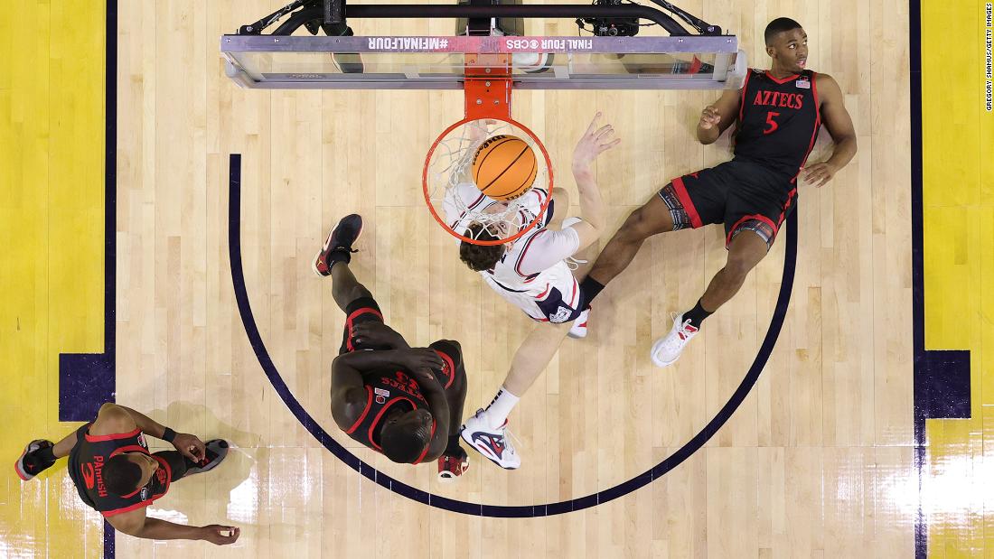 Butler, right, takes a charge on Clingan during the first half. At halftime, UConn led 36-24.