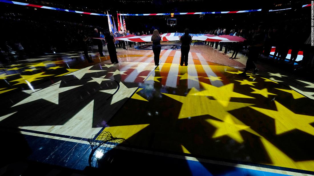 The flag is unfurled for the National Anthem before the game.