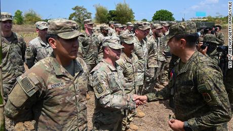 Philippine Gen. Francis Coronel, right, shakes hands with US Army soldiers after a live-fire exercise during a March 31 joint exercise between the Philippines and the US at Fort Magsaysay in the Philippines.