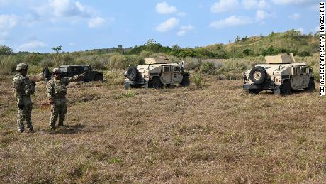 US Army soldiers stand next to their Humvies prior to a live-fire exercise with Philippine troops at Fort Magsaysay in the Philippines on March 31.