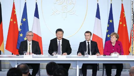 Then-European Commission President Jean-Claude Juncker, Chinese leader Xi Jinping, French President Emmanuel Macron, then-German Chancellor Angela Merkel attend an event in Paris in 2019. 