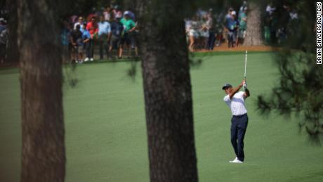 Woods hits his approach on the 7th hole.