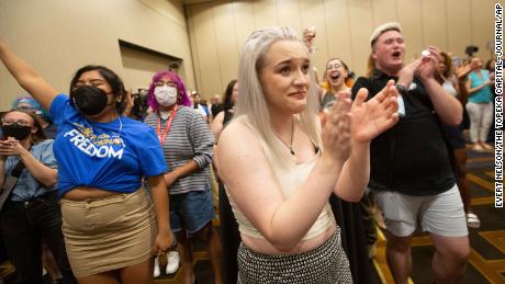 Allie Utley, center, holds back tears after hearing that voters rejected a proposed amendment to the Kansas Constitution, which would have allowed lawmakers to ban abortion in the state, at the Overland Park Convention Center on Tuesday, August 2, 2022. 