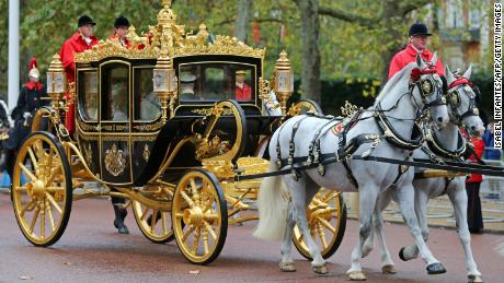 Britain&#39;s Queen Elizabeth II rides with then-Prince Charles and Camilla in the Diamond Jubilee State Coach in 2019 to the State Opening of Parliament. 