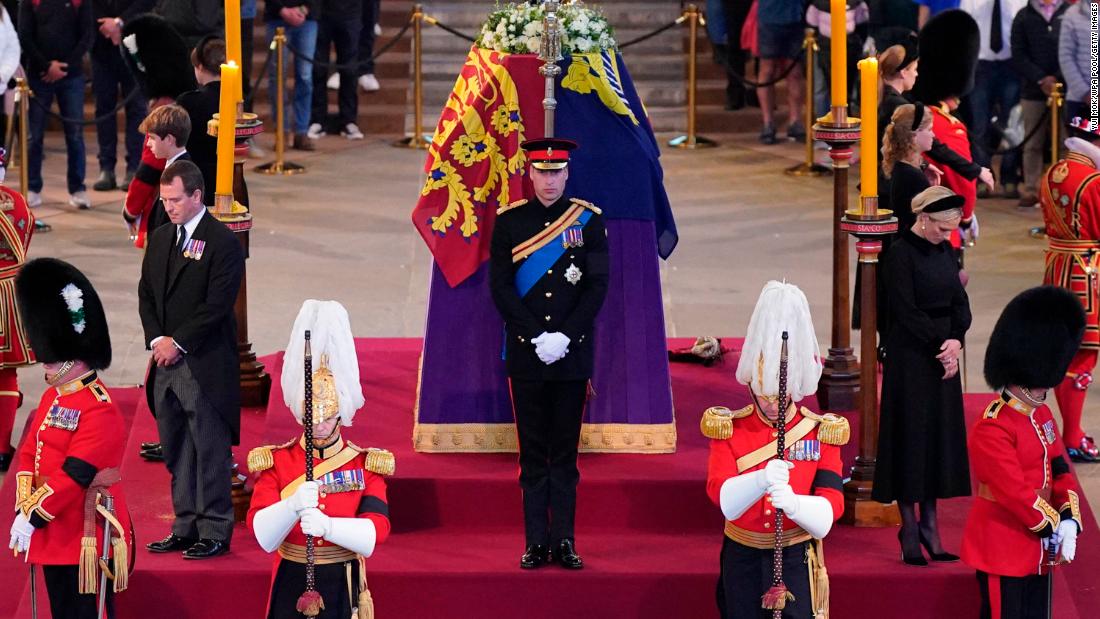 Prince William, center, and other grandchildren of Queen Elizabeth II stand vigil at her coffin in September 2022. She was lying in state at Westminster Hall.