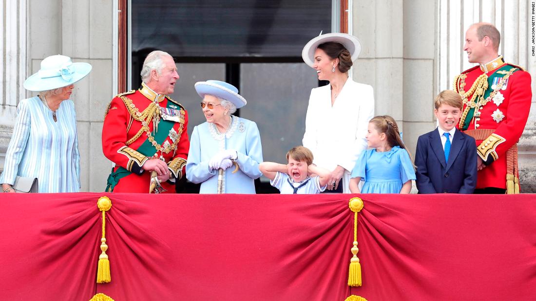 Prince Louis holds his hands over his ears as jets roar over Buckingham Palace during the Trooping the Colour parade in London in June 2022. From left are Camilla, the Duchess of Cornwall; Prince Charles; Queen Elizabeth II; Louis; Catherine; Charlotte; George; and William.