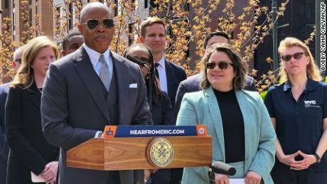 New York Mayor Eric Adams, left, introduces Kathleen Corradi, center, as the city&#39;s first-ever citywide director of rodent mitigation, also known as the &quot;rat czar,&quot; in New York on Wednesday.