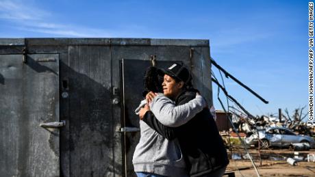 Tracy Harden (Right) hugs Barbara Nell McReynolds-Pinkins near the walk-in cooler where they and seven others took shelter as a tornado destroyed Harden&#39;s restaurant in Rolling Fork, Mississippi.