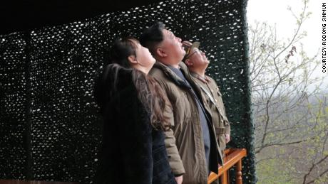 Kim Jong Un, center, and his daughter, left, watch Thursday&#39;s missile launch in a photo released by state media.
