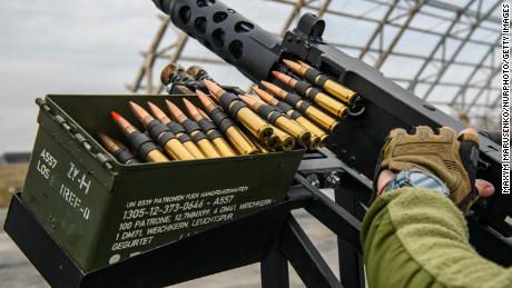 A member of Ukraine&#39;s mobile air defense group, or so-called drone hunters, checks a  Browning machine gun on top of a pick up truck at the Hostomel airfield near Kyiv, Ukraine, on April 1, 2023.