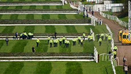 Police officers respond to protestors attempting to invade the race course ahead of the Grand National. 