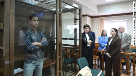 US journalist Evan Gershkovich, arrested on espionage charges, stands inside a defendants&#39; cage before a hearing to consider an appeal on his arrest at the Moscow City Court in Moscow on April 18, 2023.