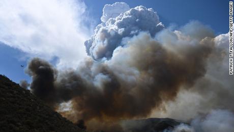 Smoke rises into smoke clouds as firefighters work to contain the Fairview Fire on September 7, 2022, in the San Bernardino National Forest in California.