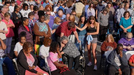 Mourners embrace during a vigil in Dadeville on Sunday, the day after the massacre.