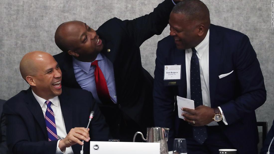 From left, US Sens. Cory Booker and Scott joke with Columbia Mayor Steve Benjamin during an economics session for the US Conference of Mayors in January 2018.