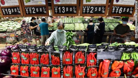 Customers shop for vegetables at a supermarket in July 2022 in China&#39;s Hebei province.