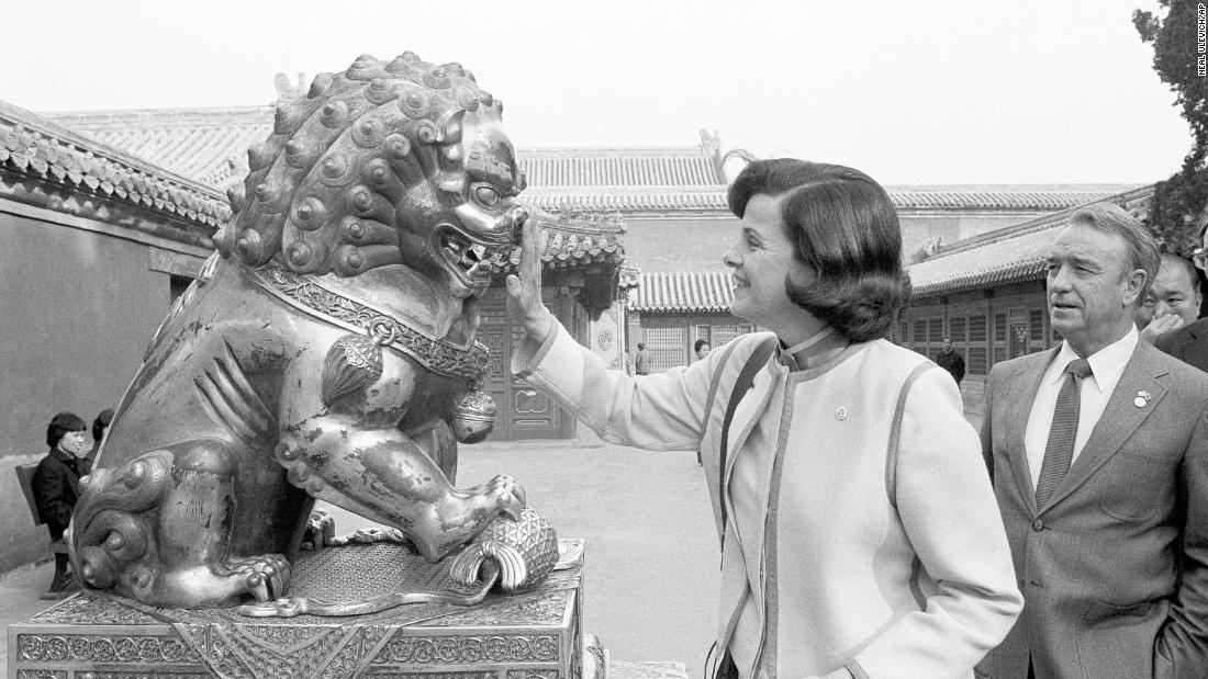 Feinstein touches the nose of a bronze lion at the Forbidden City in Beijing during a visit to China in 1984.