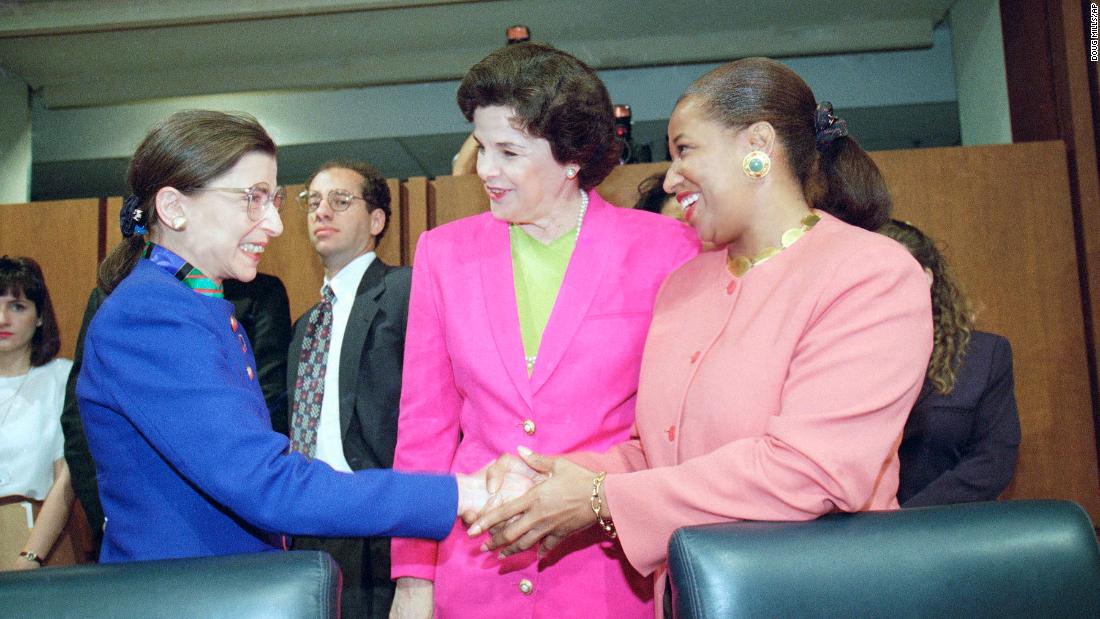 Feinstein looks on as Supreme Court nominee Judge Ruth Bader Ginsburg shakes hands with Sen. Carol Moseley-Braun prior to Ginsburg&#39;s confirmation hearing before the Senate Judiciary Committee on Capitol Hill in 1993.